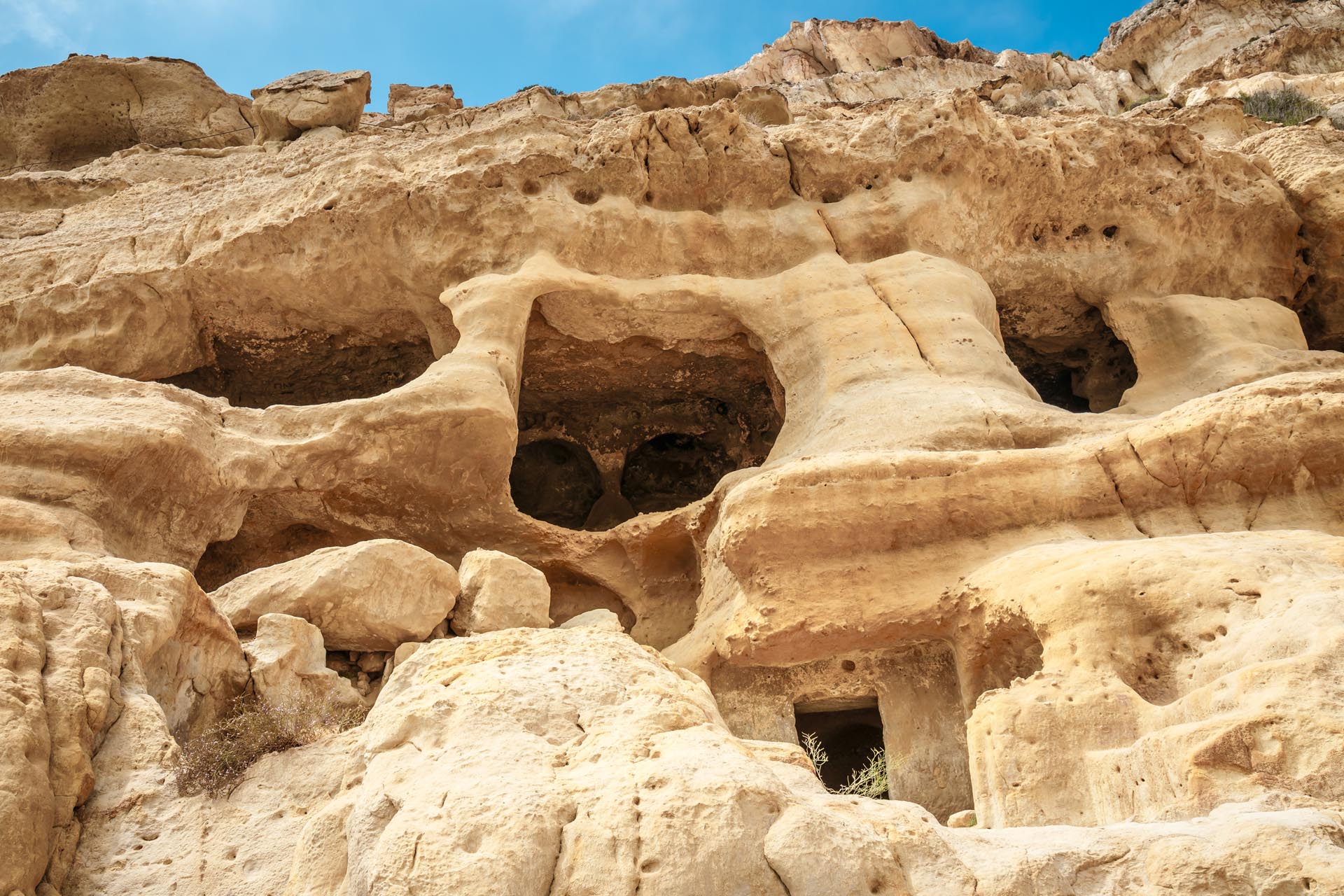 Kouvalite Car Rental | Rent a Car Herkalion, Crete picture of the caves that were use as a roman cemetery and the decade of 70's were living hippies from all over the world in Matala, Crete