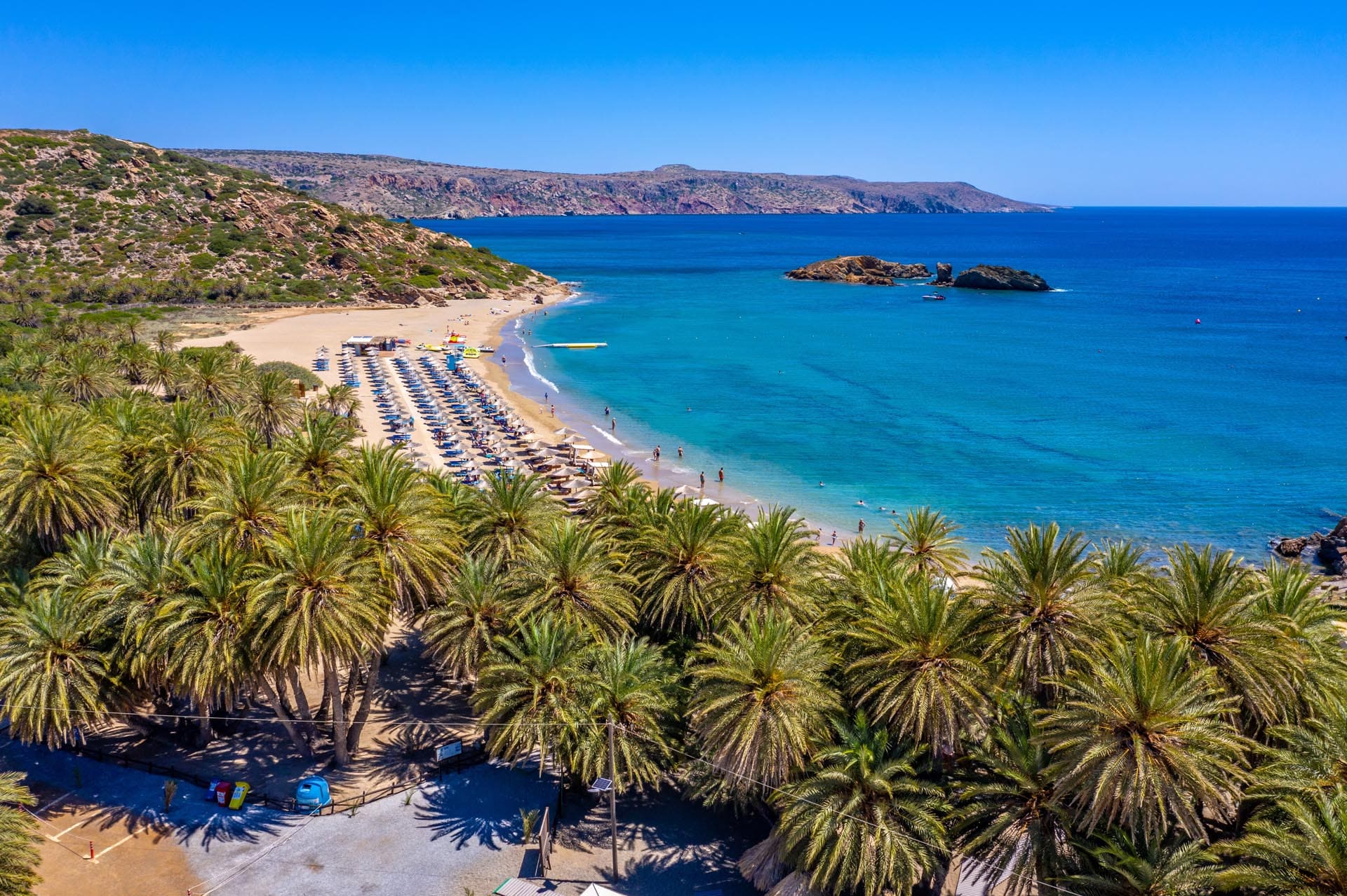 Kouvalite Car Rental | Rent a Car Herkalion, Crete Aerial view of beach with palm trees